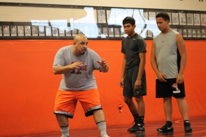 Coach Perez shows the new wrestlers some tricks.